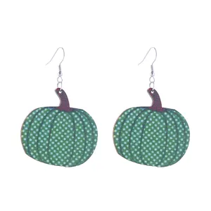 Green pumpkin drop earrings detail view, ideal for autumn holiday Halloween fashion accessories.
