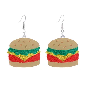 Detailed closeup of cute acrylic burger dangle earrings with vibrant glitter layers and metal hooks.