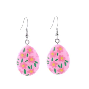Detailaufnahme süßer rosa Osterei-Ohrringe mit Blumenmuster und silbernen Ohrhaken.