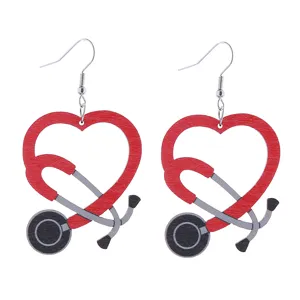 Detailed shot of wooden nurse stethoscope heart earrings, medical theme jewelry.