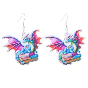 Detailed view of fantasy blue dragon and books wooden earrings, school and book lover style.