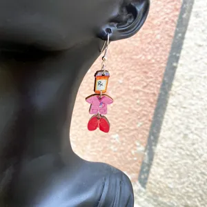 Detailed view of wooden nurse themed drop earrings with stethoscope and medical charms.