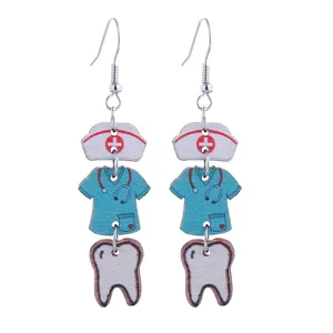 Detailed view of creative wooden nurse earrings featuring cute medical caps, scrubs and teeth.