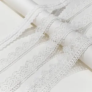 Close-up view of white polyester milk silk embroidery lace trim, hollow water-soluble fabric.