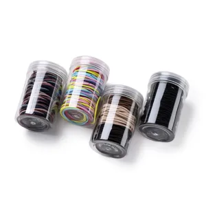 Detailed view of colorful elastic hair ties neatly packed in four transparent plastic storage jars.