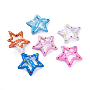 Detailed shot of colorful metal star hair clips with hollow design and cute polka dot painted finish.