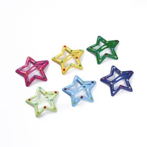 Close up view of colorful star shaped snap hair clips with painted dot decorations for kids.