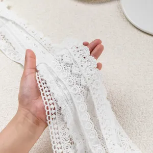 White lace trim detail, polyester milk silk embroidery, elegant hollow out design for DIY crafts.