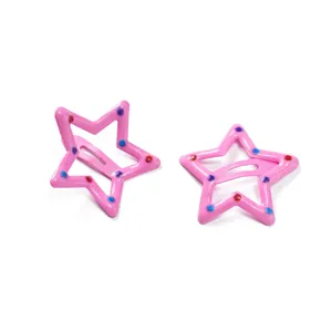 Close up detail of cute pink star hair clips with colorful dotted flocking, ideal for kids.