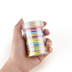 Detailed close-up view of colorful elastic hair ties packaged in a clear storage jar.