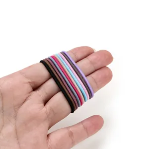 Close-up display of colorful thin elastic hair ties showing high stretchability and fine texture.