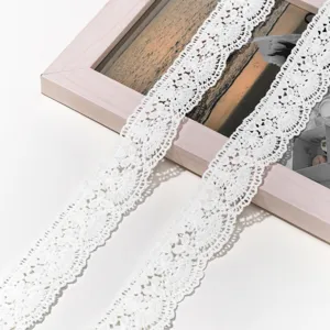 White lace trim detail featuring delicate hollow embroidery for DIY sewing hair accessories.