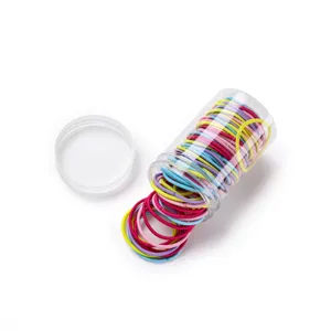 Close-up detail of colorful elastic hair ties in a clear plastic container, ideal for styling.