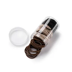 Detail view of colorful elastic hair ties packaged inside a clear plastic storage container.