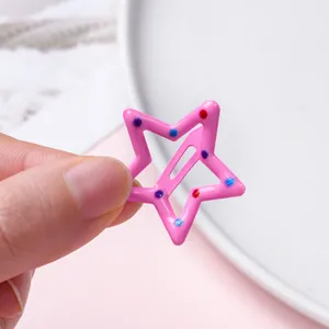 Cute pink star hair clip for kids metal snap barrette with colorful dots detail accessory.