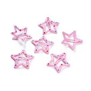 Close-up detail of cute pink star hair clips with colorful dots, lovely BB hair accessories.