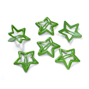 Detailed close-up shot of green metal star hair clips with hollow pentagram snap design.