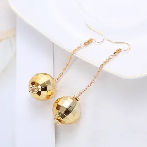 Retro disco ball long chain dangle earrings close-up detail showing faceted gold spheres.