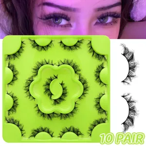 Fluffy dramatic false eyelashes detail view, displaying 10 pairs on a vibrant green tray.