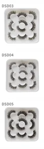 Detailansicht fluffiger künstlicher Wimpern in weißen Schalen, natürliches dichtes Design.