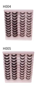 Detailansicht fluffiger falscher Wimpern im russischen Volumenstil auf rosa Präsentiertabletts.