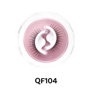Nahaufnahme von klebstofffreien künstlichen Wimpern mit rosa Glitzerschale und Dose.