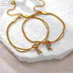 Detailed view of 18K gold plated stainless steel snake chain bracelet with crystal letter charm.