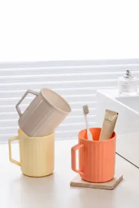 Tazza porta spazzolino in plastica con scanalature verticali e manico per bagno.