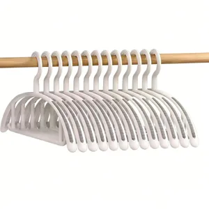 Non-slip clothes hangers with traceless shoulder design, plastic garment racks for home dorm use.