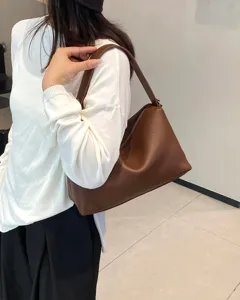 Stylish brown leather shoulder bag for women, premium soft cowhide underarm pillow purse.