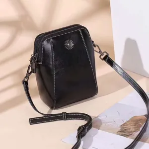 Black leather cross-body bag detail, chic shoulder phone bag with stylish contrast stitching.