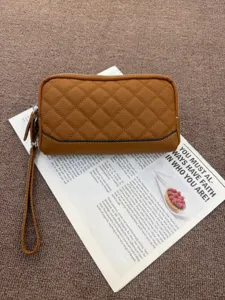 Detailed view of the quilted genuine cowhide leather wristlet wallet, showing fine texture.
