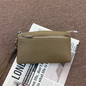Genuine leather clutch bag detail, daily commute wristlet wallet, minimalist style.