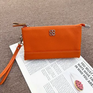 Orange leather coin purse and clutch bag with wrist strap, genuine leather wallet for women.
