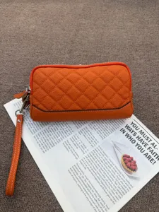 Genuine leather quilted long zippered wallet and clutch bag for women with wrist strap.