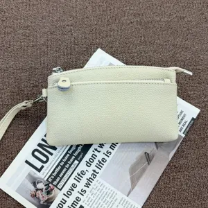 Genuine leather wristlet clutch purse for women, compact coin pouch and phone bag with zipper design.