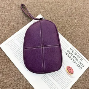 Purple leather wristlet coin purse for women, compact pebble grain clutch bag with zipper.