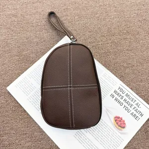 Brown genuine leather coin purse clutch with wrist strap and contrast white stitching details.