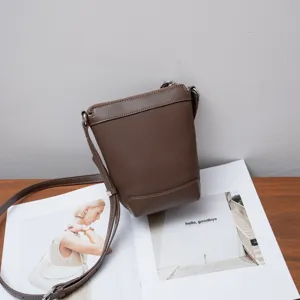 Brown genuine leather crossbody bag detail, versatile casual small shoulder bag for women daily use.
