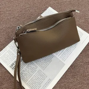 Genuine leather clutch bag with multi zippers and wrist strap for women daily commute.