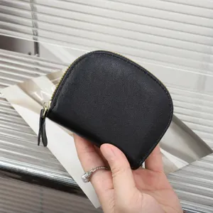 Genuine leather mini coin purse for women, black zipper card holder and small wallet detail view.