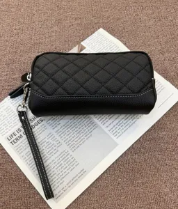 Black genuine leather quilted long wallet and phone bag with wrist strap and card slots.