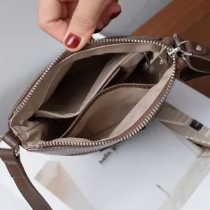 Genuine leather crossbody small bag interior detail view, premium multi-compartment design.