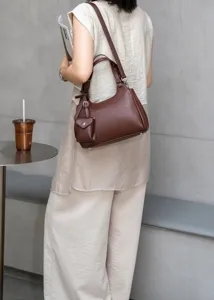 Brown genuine leather shoulder bag detail view, stylish daily crossbody handbag with mini pouch.