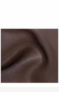 Close-up shot of premium brown cowhide leather material showing soft texture and fine grain detail.