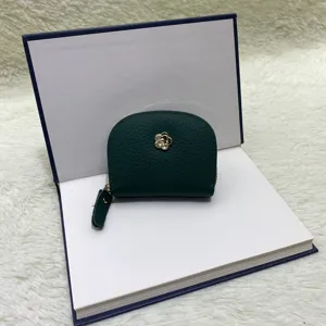 Dark green leather coin purse mini card holder with gold flower charm and zipper closure.