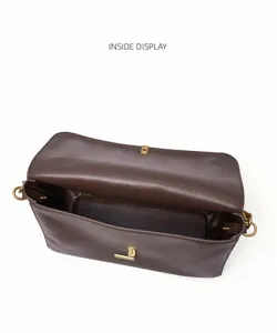 Detail view of the brown leather shoulder bag interior, showing large capacity and nice lining.