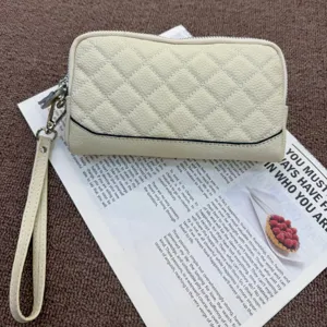 Genuine leather quilted zip-around wallet for women, stylish wristlet clutch purse with card slots.