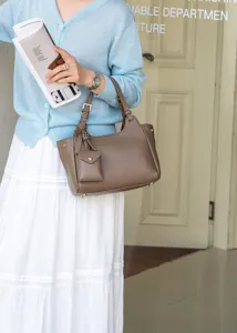 Natural cowhide leather shoulder bag with small pendant, stylish crossbody handbag for women.