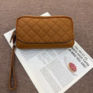 Brown genuine leather quilted wallet clutch for women with wrist strap and zipper closure.